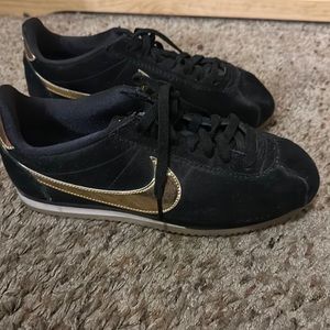 Black and gold Nike Cortez